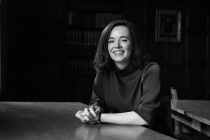 Black and white image of woman sitting at table