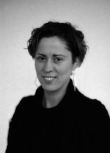 Black and white image of Teresa Dillon with short hair and hoop earrings