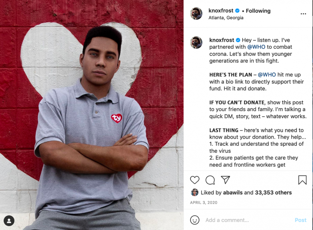 Instagram image of Knox Frost wearing a grey polo shirt in front of a wall painted with a red and white heart