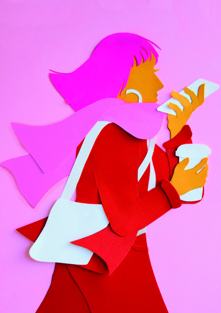 An illustration made out of colourful cut paper. It shows a woman with pink hair and a red coat walking on a windy day. She holds her phone up to her mouth to record a voice note