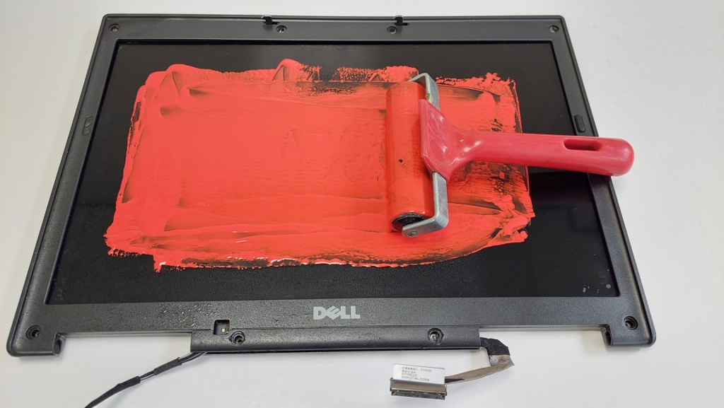computer screen used as ink pad with red paint
