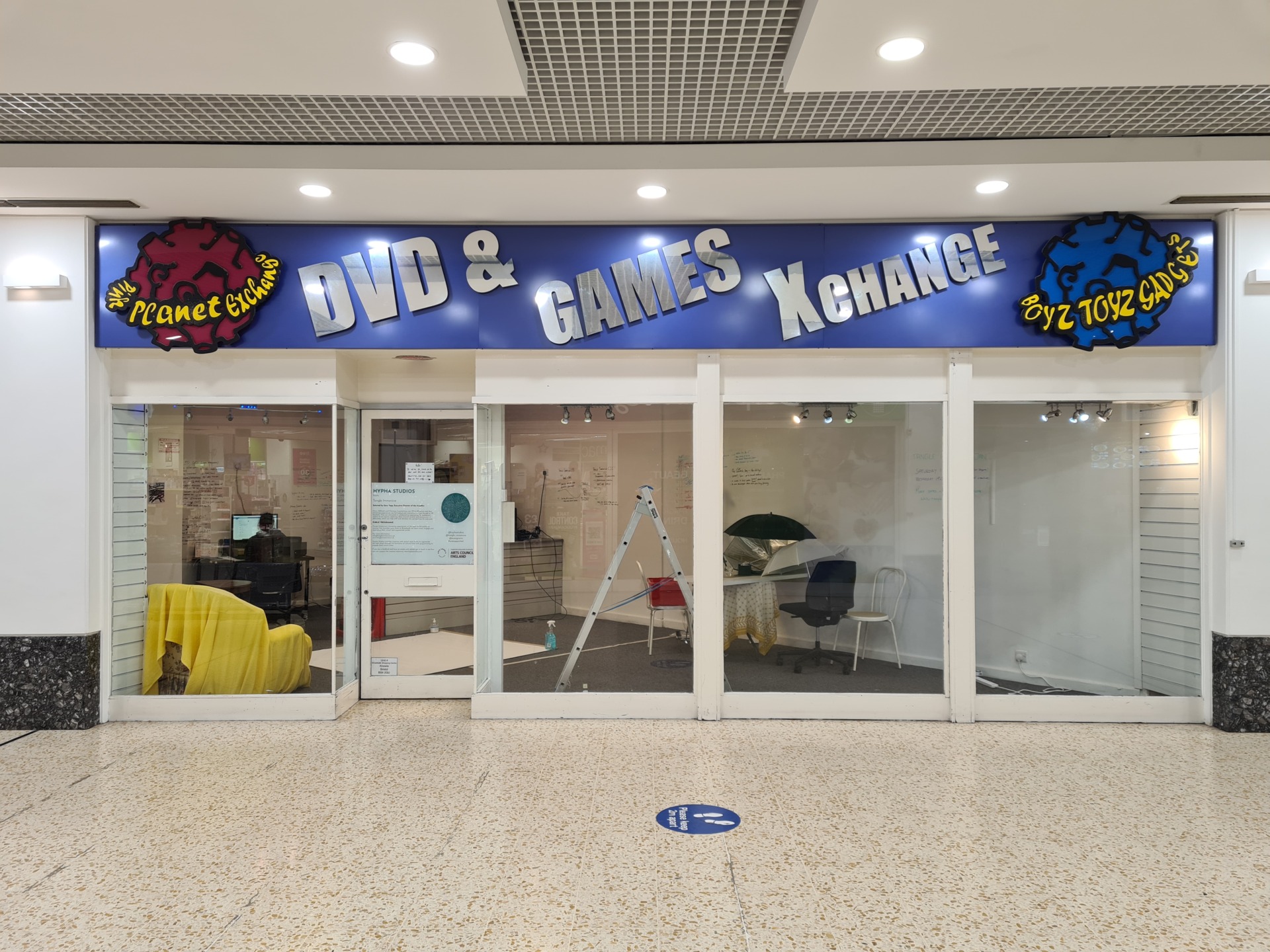 Shop front image with sign that says DVD & Games Exchange