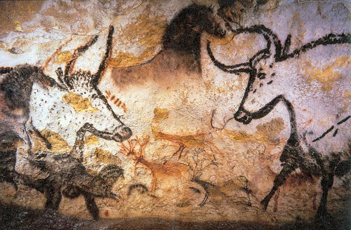 Cave art paintings of oxen horses and deer in one section of wall