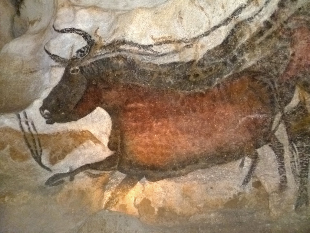 A Lascaux cave painting of a bull in motion, painted with dark hide