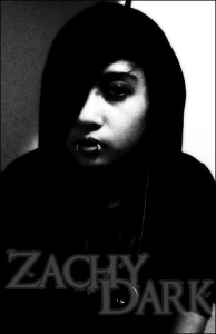 young person in high shadow with hood on lip piercing, text at the bottom: Zachy Dark