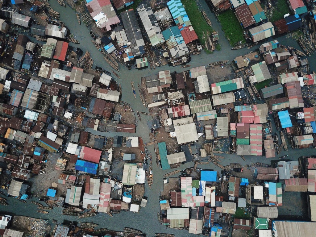 Aerial view of canal streets between shacks, from a drone