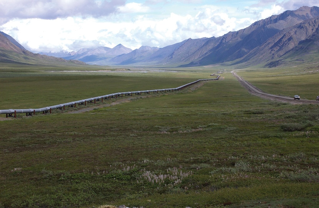 a pipeline runs across a valley of natural beauty into the far distance