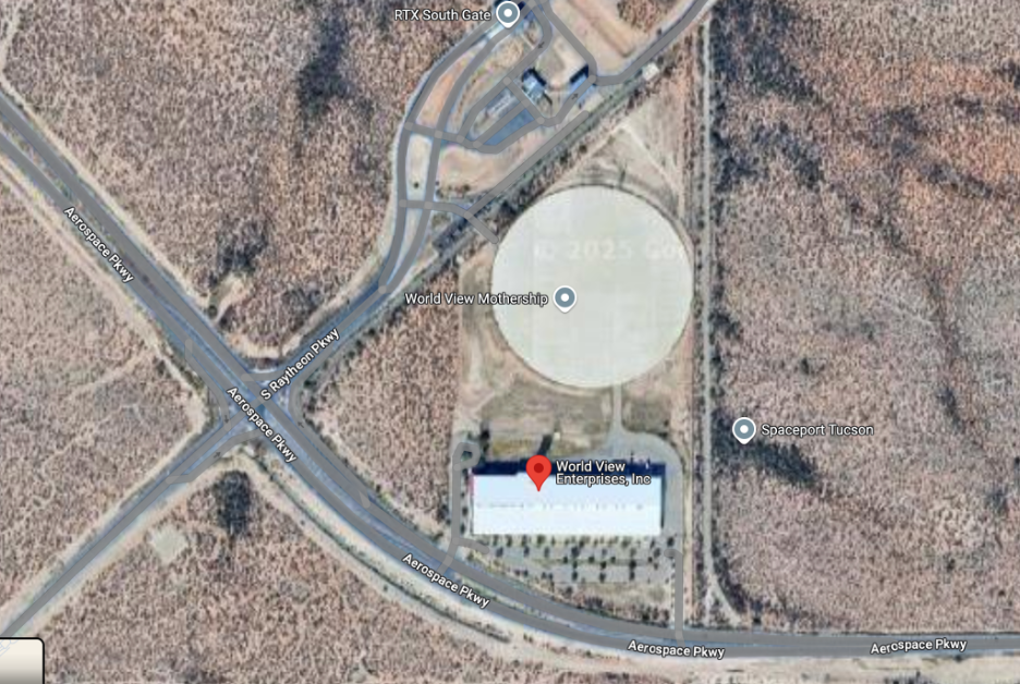 satellite image of large round site in a desert with intersecting roads, marked as World View and Spaceport
