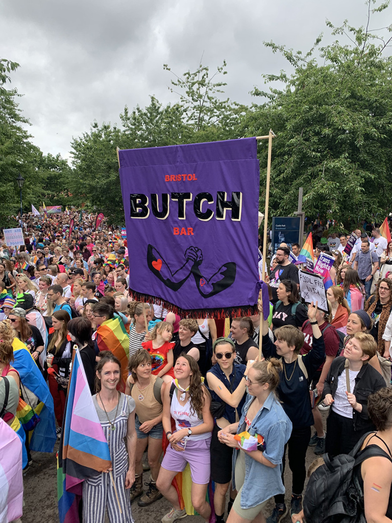 bristol pride parade with bristol butch bar banner in focus